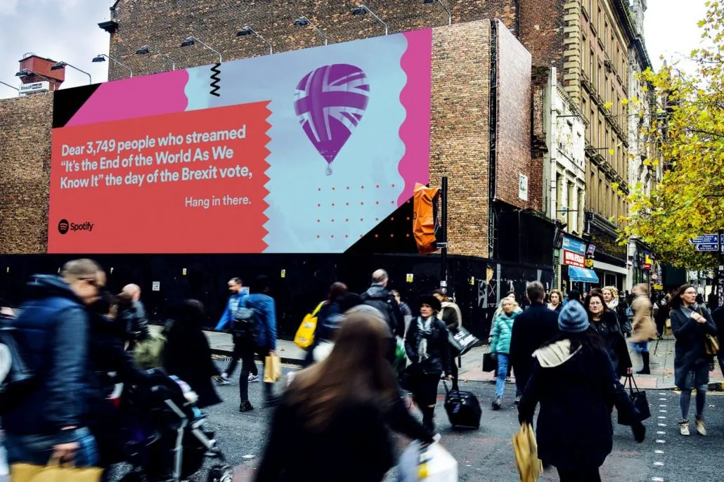 Spotify billboard above a busy shopping street: “Dear 3,749 people who streamed ‘It’s the End of the World As We Know It’ the day of the Brexit vote, Hang in there.”