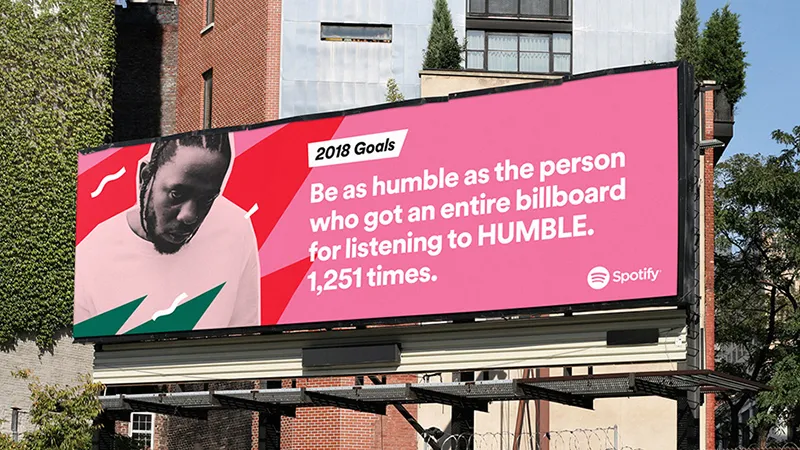 Pink Spotify billboard headed “2018 Goals”: “Be as humble as the person who got an entire billboard for listening to HUMBLE. 1,251 times.”