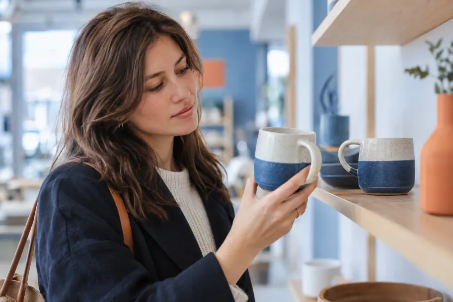 Illustrative scene: a shopper comparing two mugs